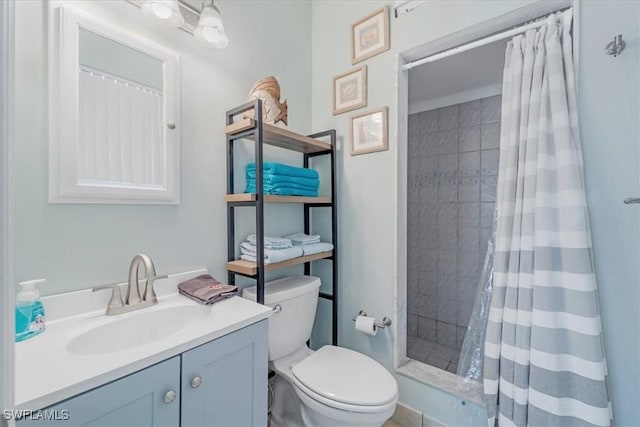 full bath featuring toilet, a stall shower, and vanity