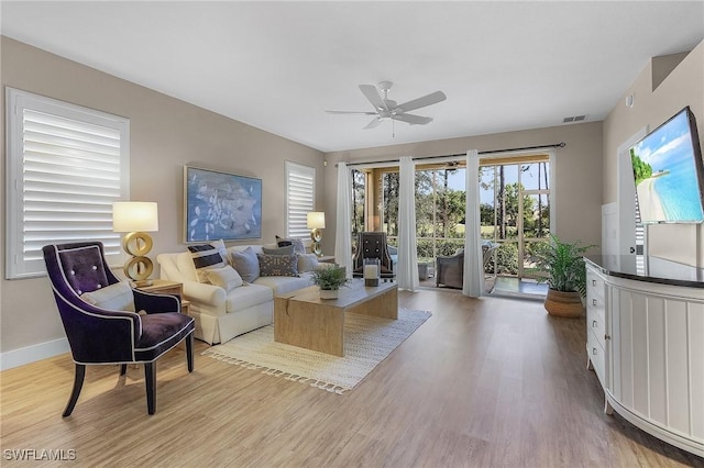 living room featuring ceiling fan and light hardwood / wood-style floors