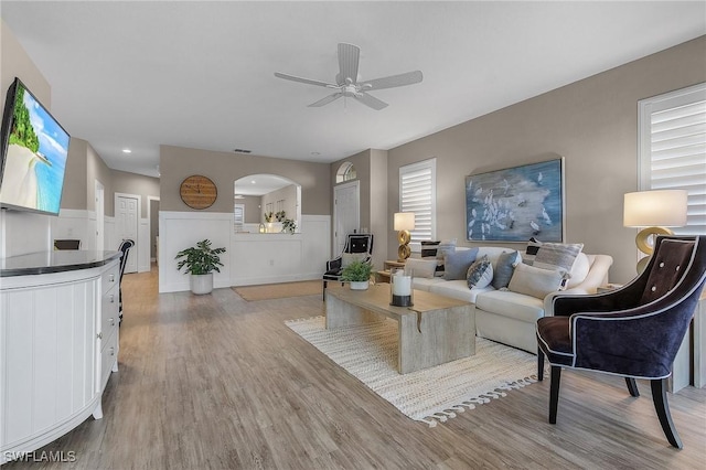 living room with ceiling fan and light hardwood / wood-style floors