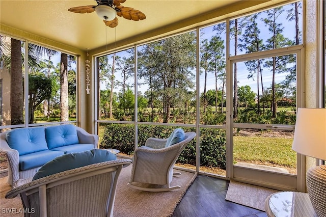 sunroom featuring ceiling fan and a wealth of natural light