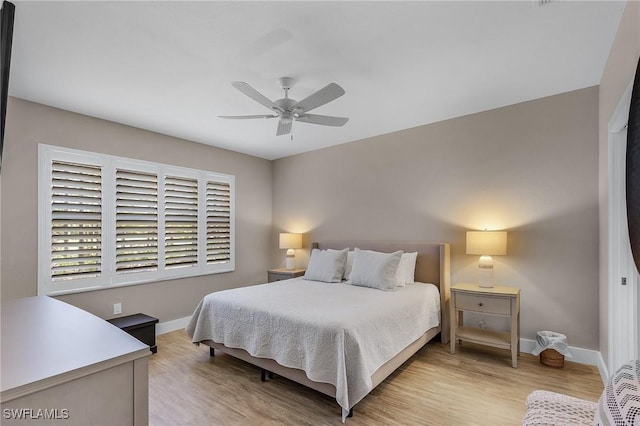 bedroom with light hardwood / wood-style floors and ceiling fan