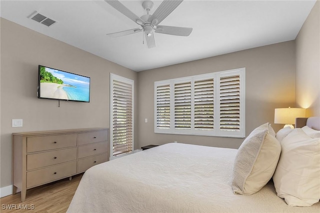 bedroom with ceiling fan and light hardwood / wood-style flooring