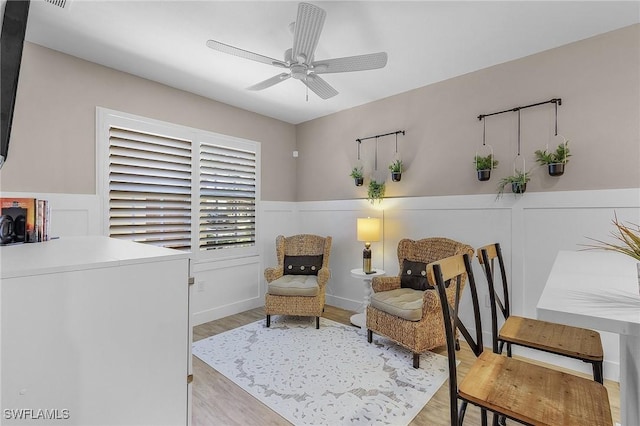 sitting room featuring ceiling fan and light hardwood / wood-style floors