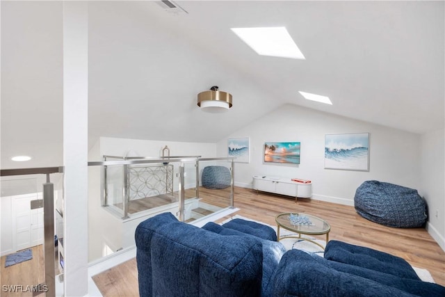 interior space with lofted ceiling with skylight and wood-type flooring