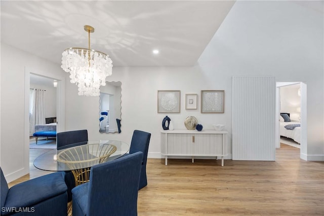 dining room featuring light hardwood / wood-style flooring and a notable chandelier