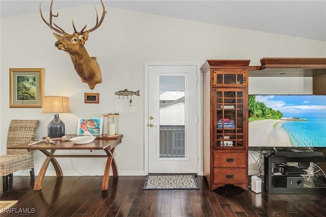 entryway with dark hardwood / wood-style flooring and vaulted ceiling