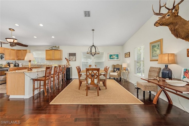 dining room with plenty of natural light, dark hardwood / wood-style floors, and lofted ceiling