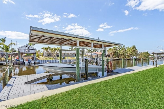 dock area with a water view and a lawn