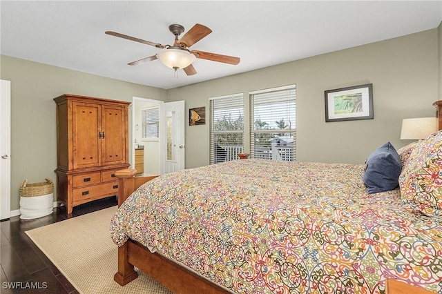 bedroom with dark hardwood / wood-style flooring and ceiling fan