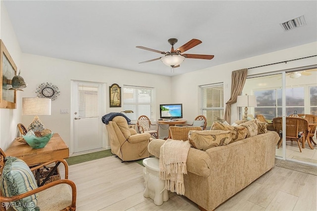 living room featuring ceiling fan and light wood-type flooring