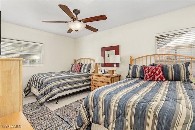 tiled bedroom featuring ceiling fan