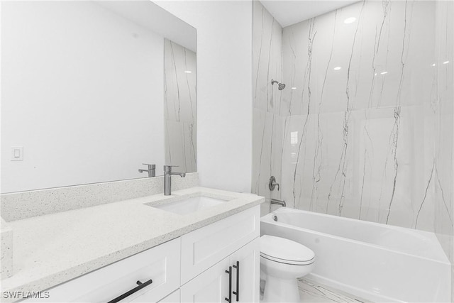 full bathroom featuring tiled shower / bath, vanity, and toilet