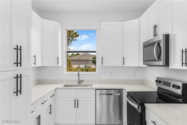 kitchen featuring white cabinetry, appliances with stainless steel finishes, and sink