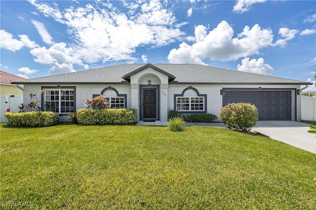 single story home featuring a garage and a front yard