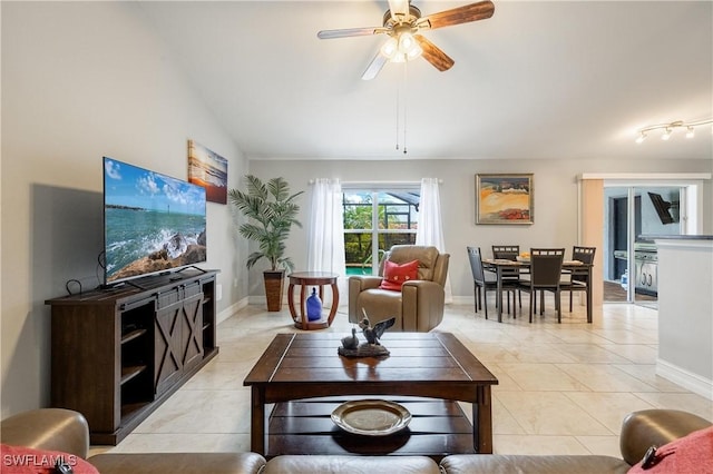 living room with ceiling fan, lofted ceiling, and light tile patterned floors