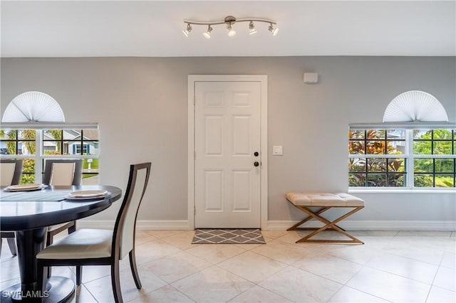 dining room with light tile patterned flooring and a wealth of natural light