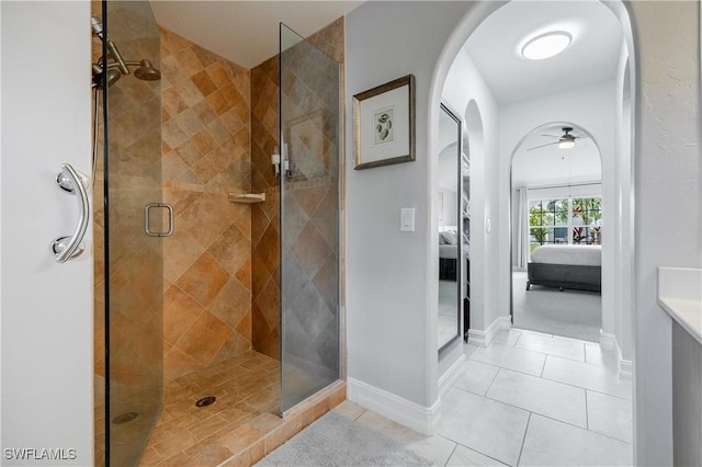 bathroom with ceiling fan, an enclosed shower, and tile patterned floors