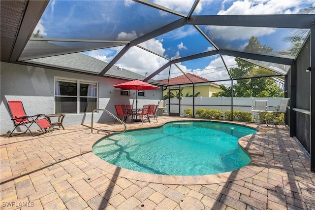 view of swimming pool with a patio and glass enclosure