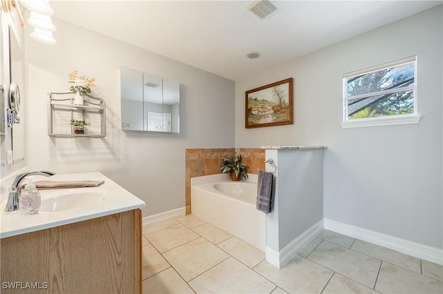 bathroom with vanity, a tub, and tile patterned floors