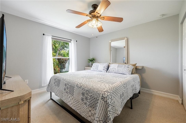 bedroom featuring light colored carpet and ceiling fan