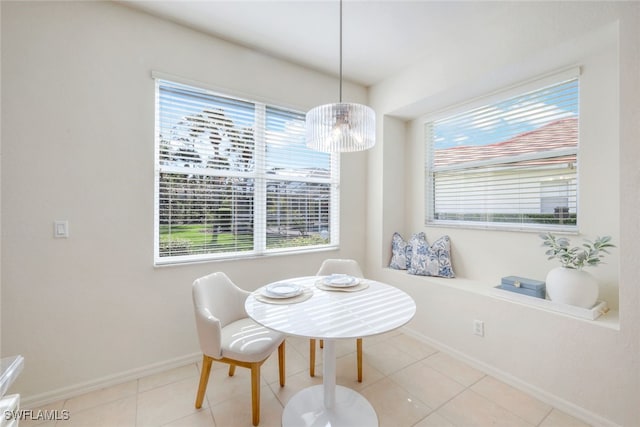 dining room with light tile patterned flooring and a healthy amount of sunlight