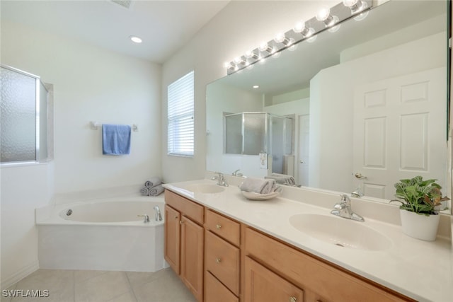 bathroom featuring vanity, plus walk in shower, and tile patterned flooring