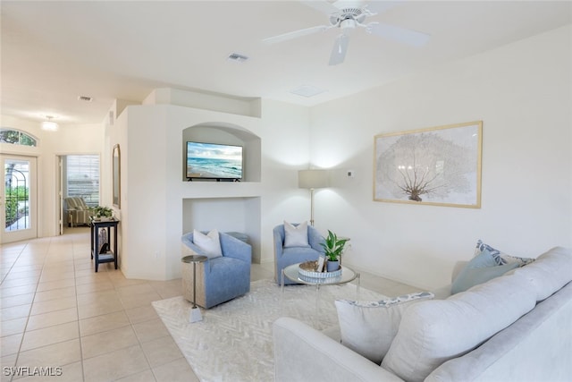 tiled living room with ceiling fan