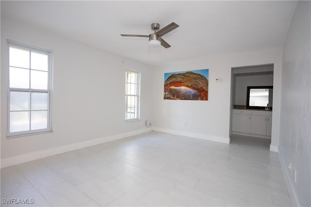 spare room featuring sink and ceiling fan