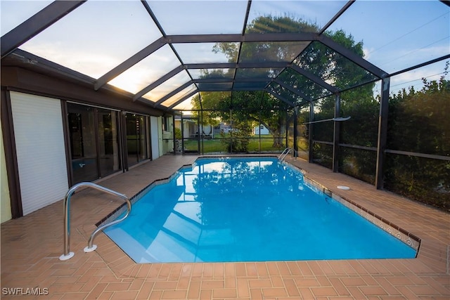 view of swimming pool with a lanai and a patio area