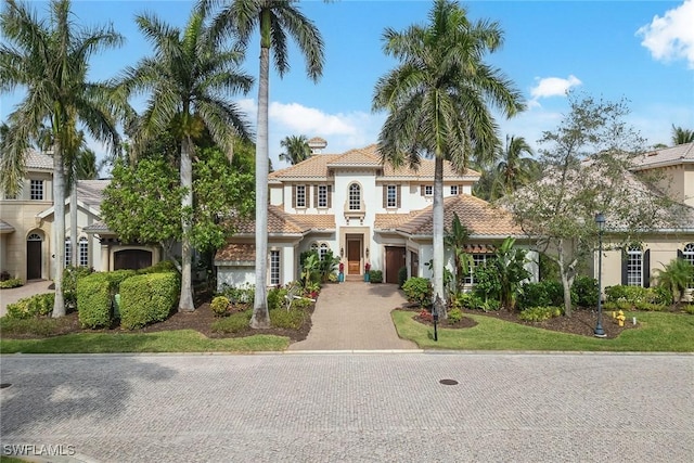 mediterranean / spanish house with a front lawn