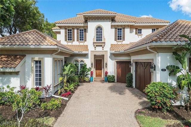 mediterranean / spanish house featuring a garage