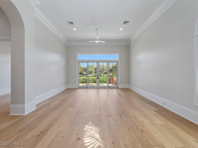 unfurnished living room with crown molding, ceiling fan, light wood-type flooring, and french doors