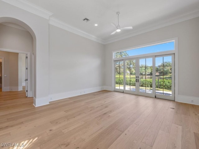 unfurnished room with crown molding, light hardwood / wood-style flooring, french doors, and ceiling fan