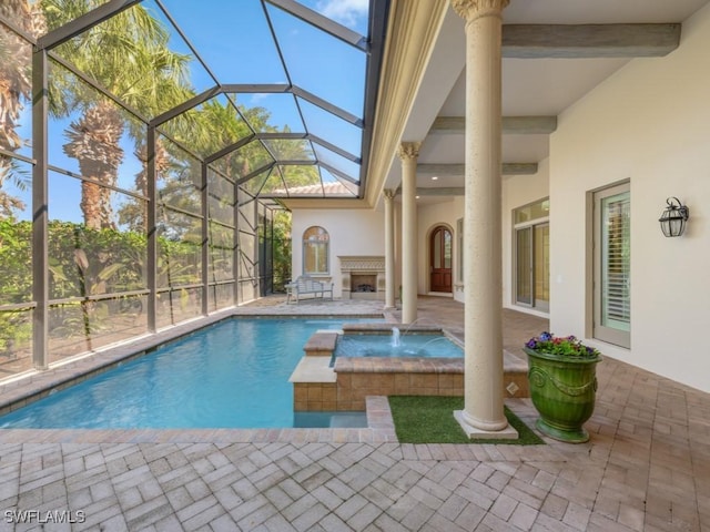 view of swimming pool with an in ground hot tub, pool water feature, glass enclosure, and a patio