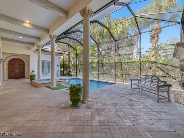 view of swimming pool featuring an in ground hot tub, a lanai, and a patio area