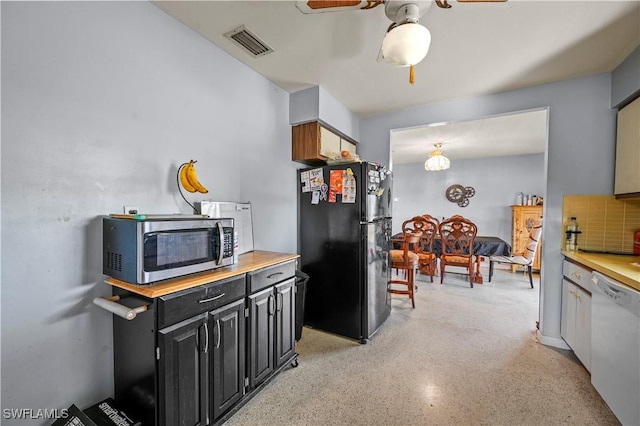 kitchen featuring dishwasher, black fridge, and ceiling fan