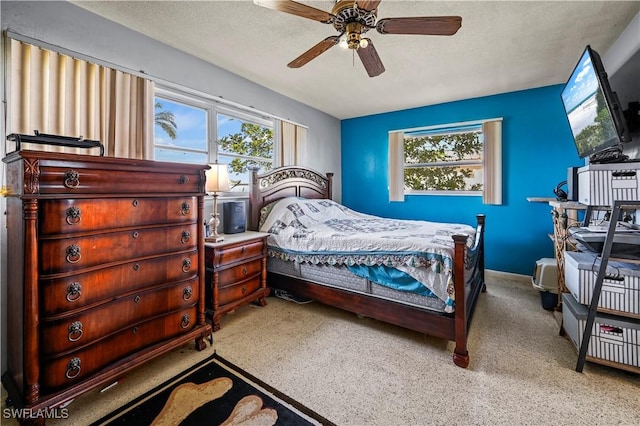 bedroom featuring ceiling fan and a textured ceiling