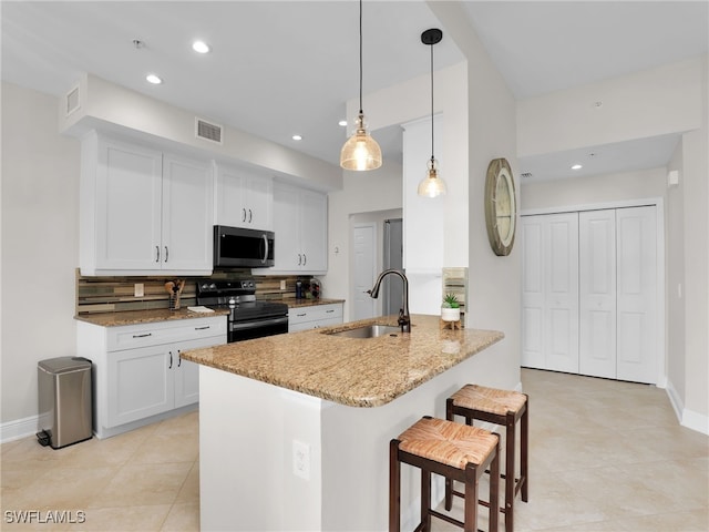 kitchen featuring sink, white cabinetry, light stone counters, black electric range, and pendant lighting