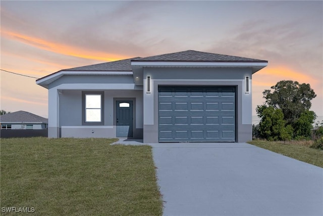 view of front of house with a yard and a garage