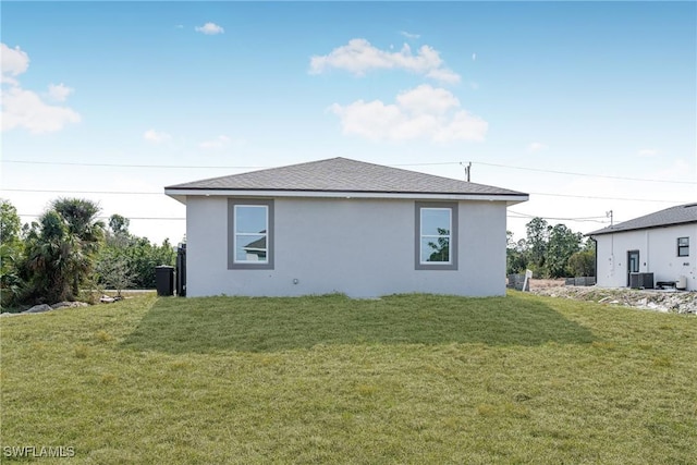 rear view of house featuring a yard