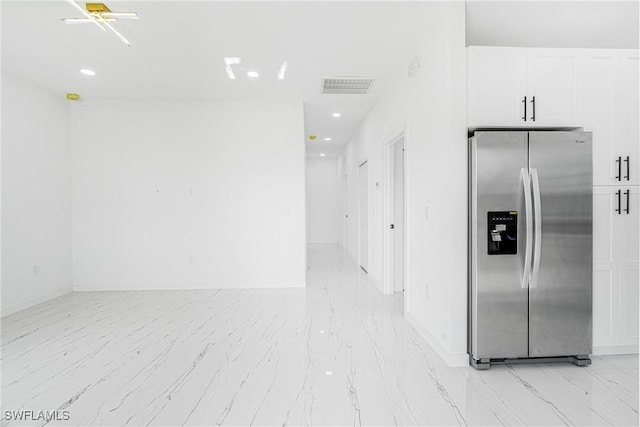 kitchen with white cabinetry and stainless steel fridge with ice dispenser