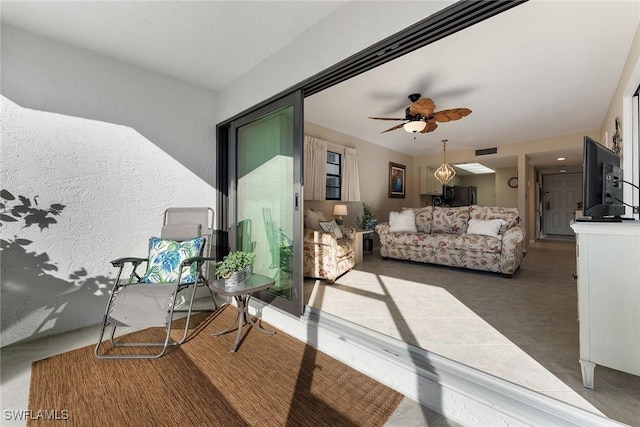 balcony featuring an outdoor living space and ceiling fan