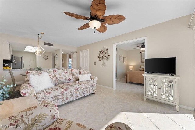 tiled living room featuring ceiling fan