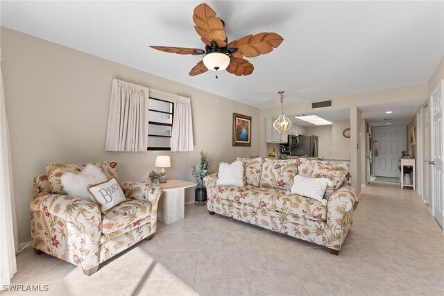 living room with light tile patterned flooring and ceiling fan