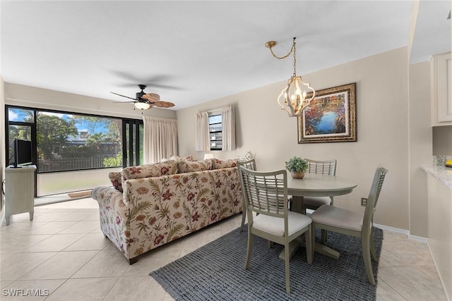 dining space with ceiling fan with notable chandelier and light tile patterned floors