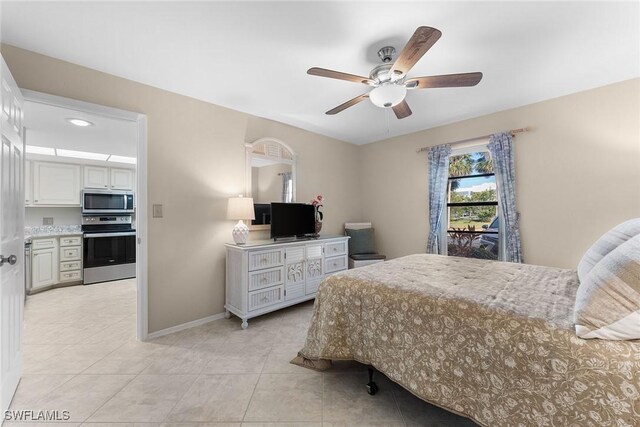 bedroom with ceiling fan and light tile patterned floors