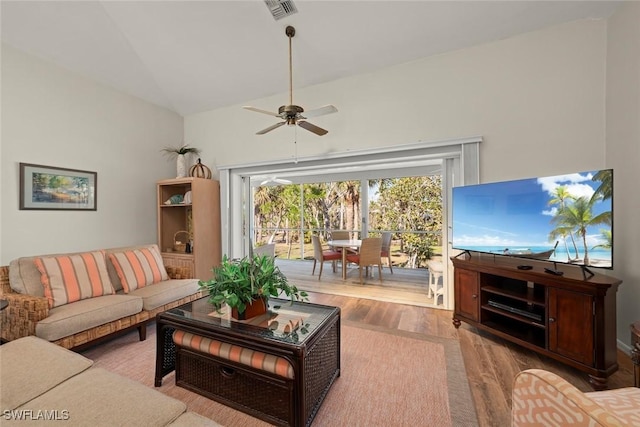 living room featuring ceiling fan, lofted ceiling, and light hardwood / wood-style flooring