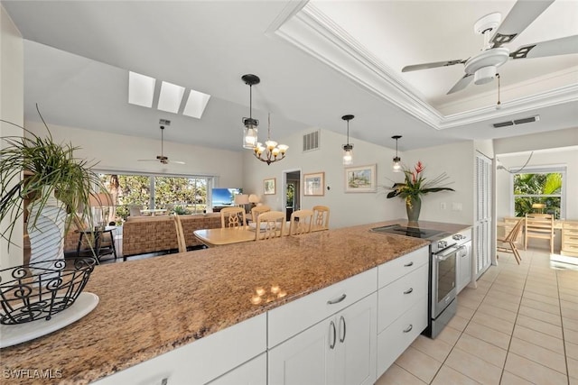 kitchen with pendant lighting, white cabinets, a raised ceiling, light stone countertops, and electric stove