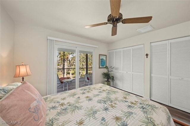 bedroom featuring wood-type flooring, two closets, access to exterior, and ceiling fan