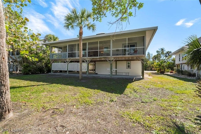 rear view of house featuring a yard and a patio area